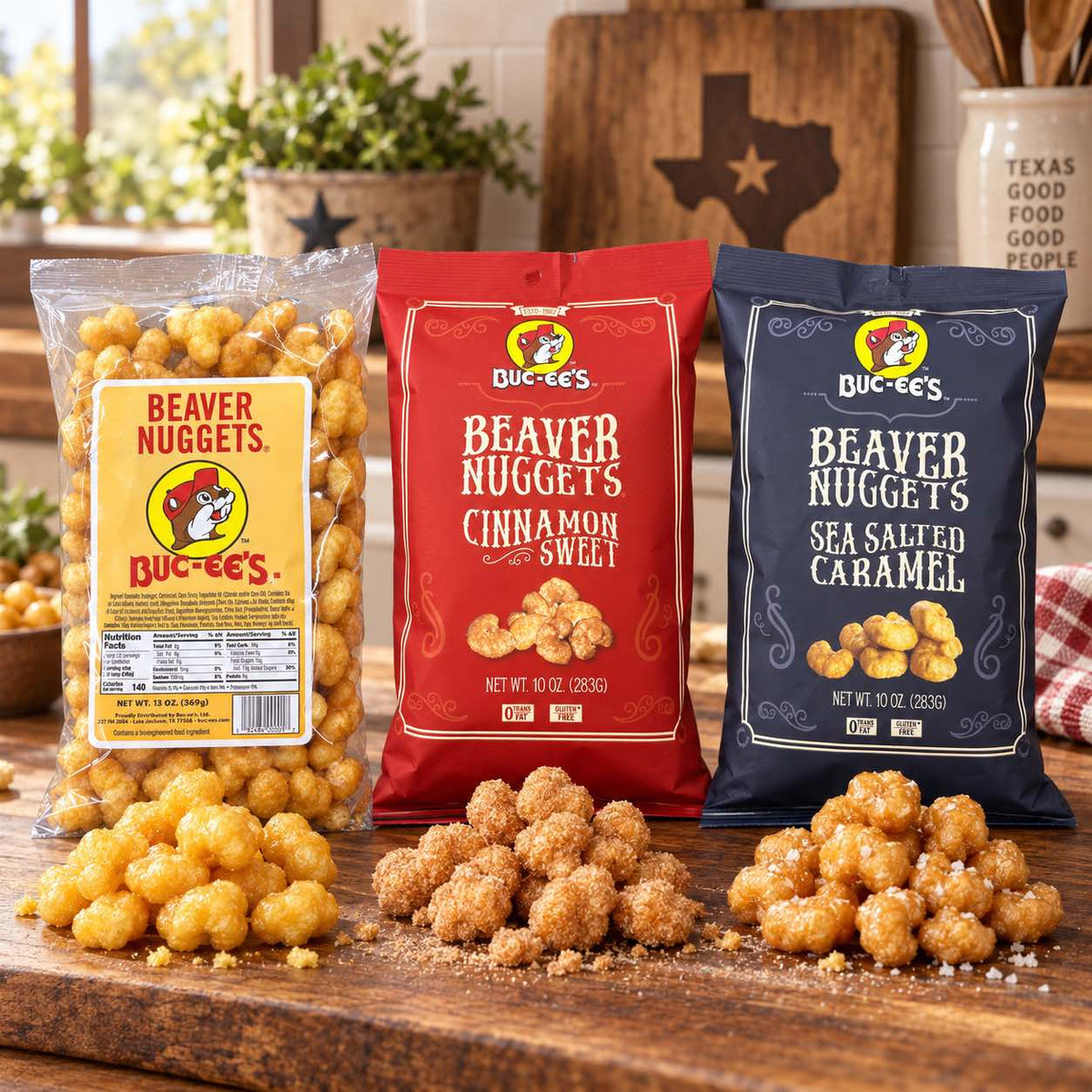Three bags of Buc-ee's Beaver Nuggets arranged on a wooden table with loose piles in front in a kitchen setting